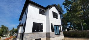 New White Siding, Stone Accents, and Black-framed Windows - York Region